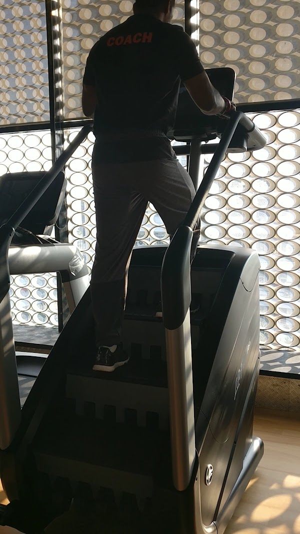 Coach on the stair climber in the cardio area